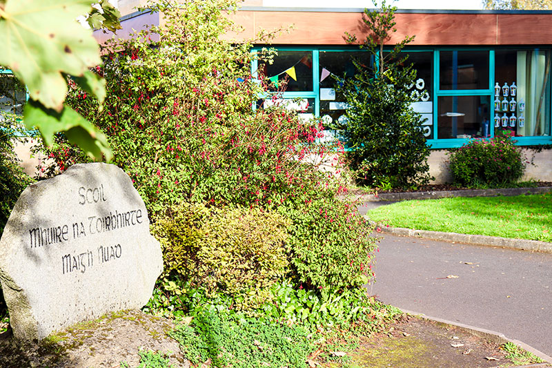 School name on stone in front of school building